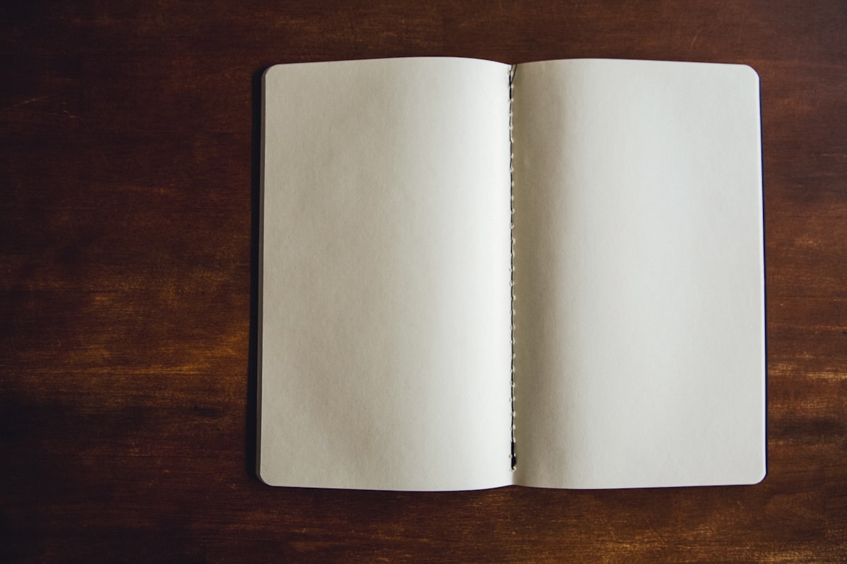 An open notebook with blank pages ready for writing